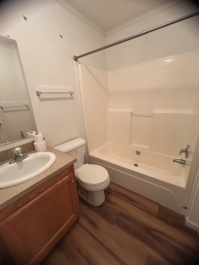 full bathroom with shower / bath combination, vanity, a textured ceiling, wood-type flooring, and toilet