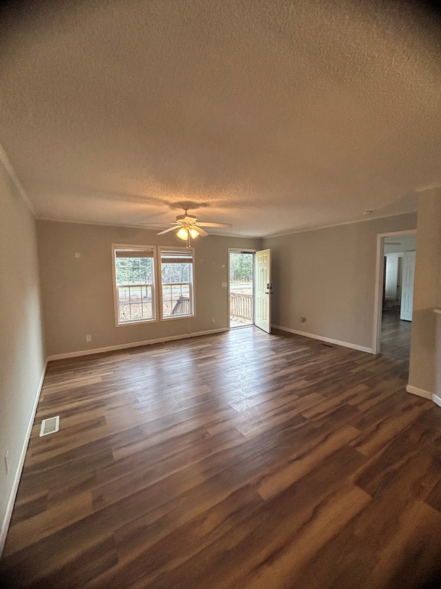 empty room featuring a textured ceiling, dark hardwood / wood-style floors, and ceiling fan