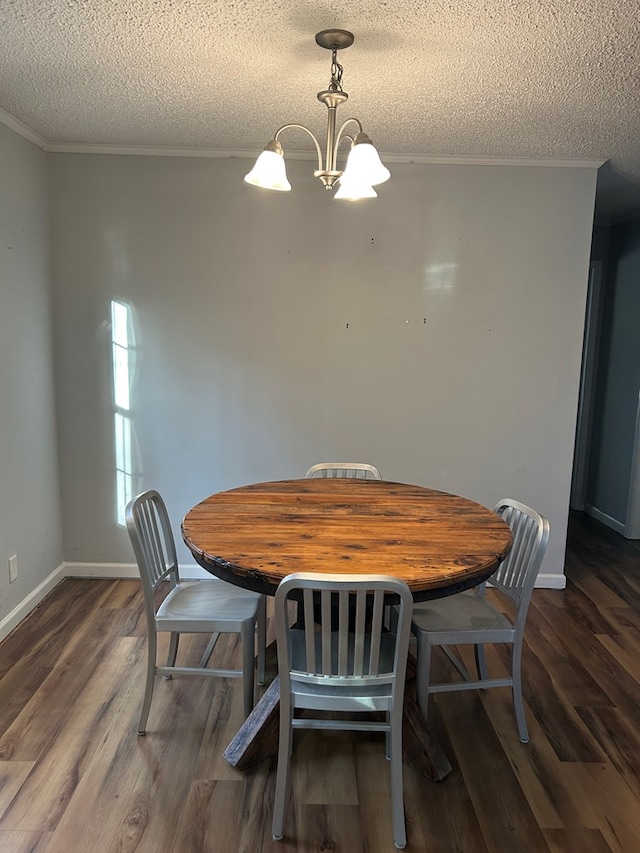 dining room featuring a chandelier, a textured ceiling, and dark wood-type flooring