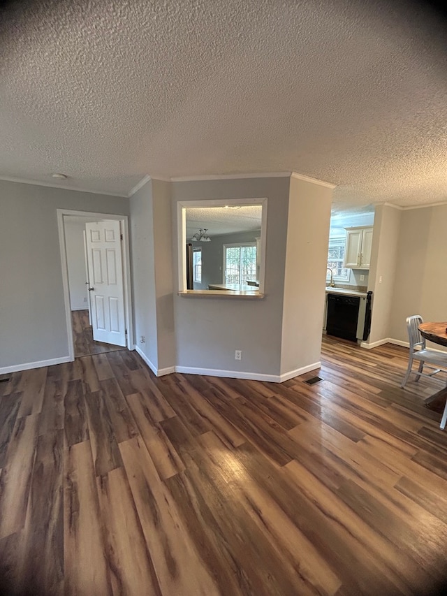 unfurnished living room featuring crown molding, dark hardwood / wood-style flooring, and a textured ceiling