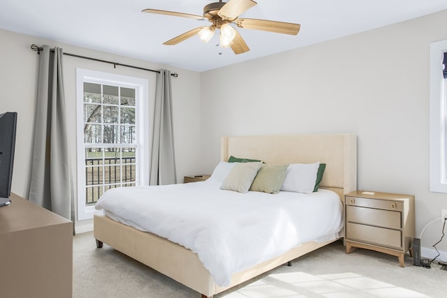 bedroom featuring light carpet and a ceiling fan