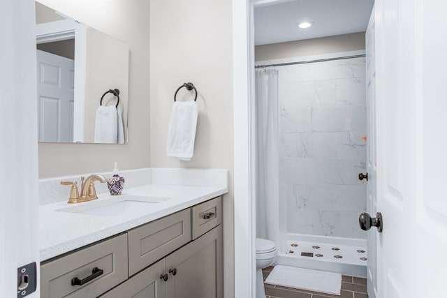 bathroom with tile patterned flooring, toilet, a shower stall, and vanity