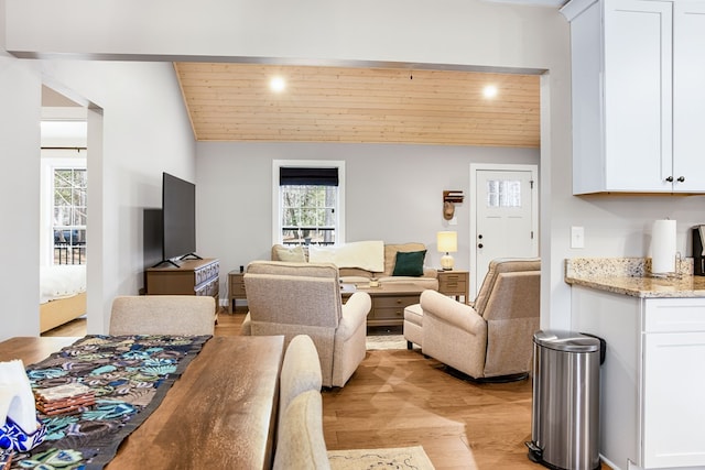 living room featuring lofted ceiling, light wood-style floors, and wood ceiling