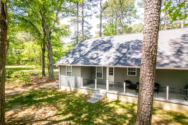 146 Portal Dr, Montross, VA 22520 - rear view of property with a shingled roof, covered porch, and a yard