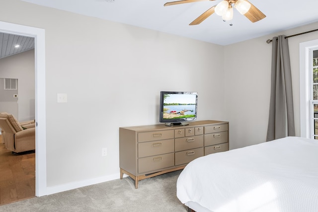 bedroom with baseboards, visible vents, ceiling fan, and light colored carpet