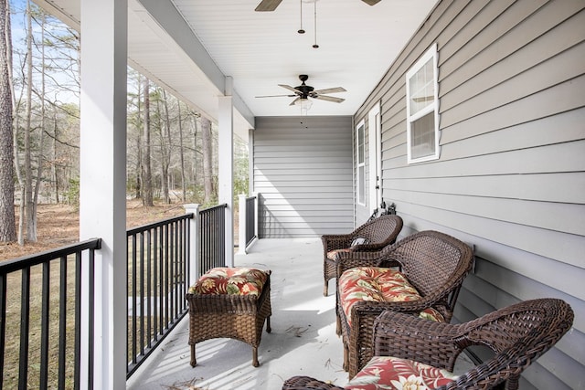 wooden deck featuring a ceiling fan and a porch