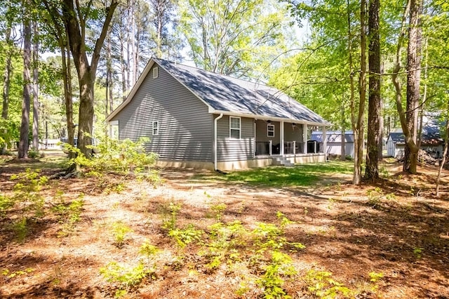 146 Portal Dr, Montross, VA 22520 - view of side of home featuring a shingled roof and covered porch