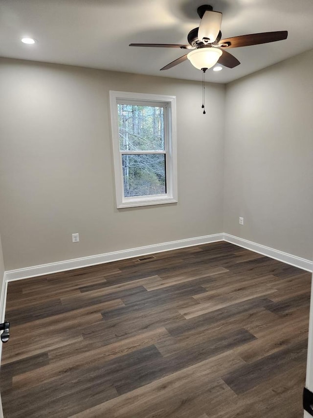 unfurnished room with ceiling fan and dark hardwood / wood-style flooring