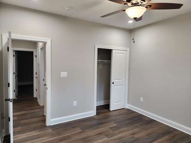 unfurnished bedroom featuring ceiling fan, dark hardwood / wood-style flooring, and a closet