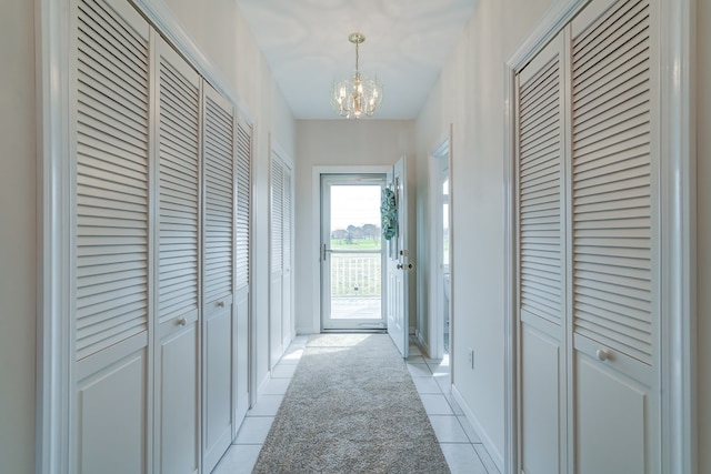 284 Palmer Dr, Lottsburg, VA 22511 - hallway with light tile patterned flooring, baseboards, and an inviting chandelier