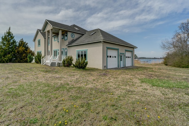 284 Palmer Dr, Lottsburg, VA 22511 - view of home's exterior featuring a water view, stucco siding, a yard, and an attached garage