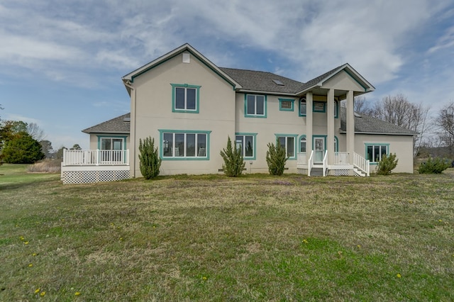 284 Palmer Dr, Lottsburg, VA 22511 - back of house featuring roof with shingles, stucco siding, and a yard