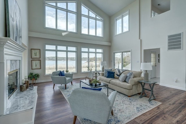 284 Palmer Dr, Lottsburg, VA 22511 - living area with dark wood-style flooring, a water view, visible vents, a premium fireplace, and baseboards