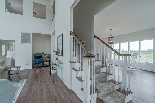 284 Palmer Dr, Lottsburg, VA 22511 - stairway with baseboards, visible vents, wood finished floors, and a chandelier