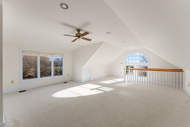 bonus room featuring ceiling fan, light carpet, and vaulted ceiling