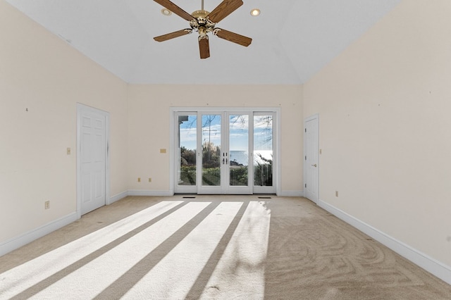 carpeted spare room featuring ceiling fan and lofted ceiling