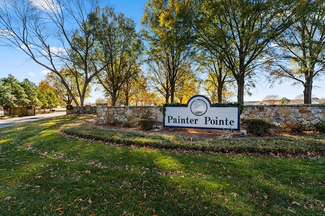 community / neighborhood sign featuring a yard