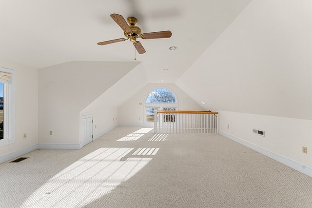 bonus room with light carpet, ceiling fan, and lofted ceiling