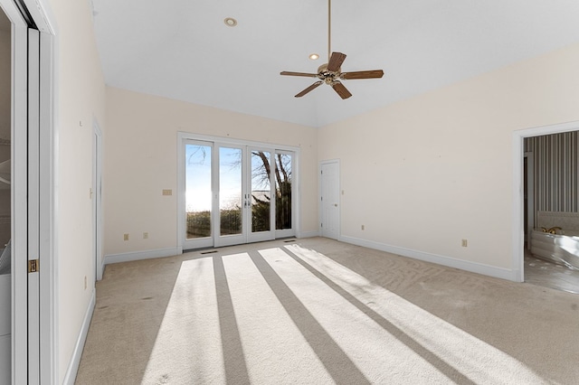 unfurnished room featuring light carpet, french doors, ceiling fan, and high vaulted ceiling