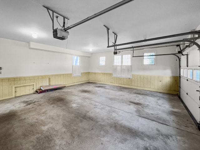 garage featuring wooden walls and a garage door opener