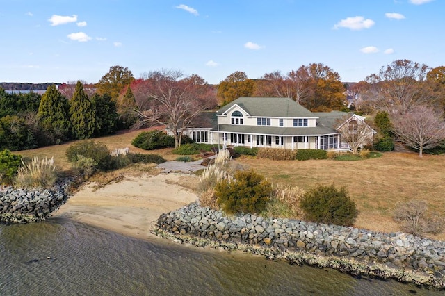 rear view of property with a water view