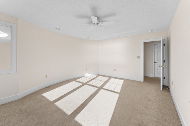 carpeted spare room with ceiling fan and a textured ceiling