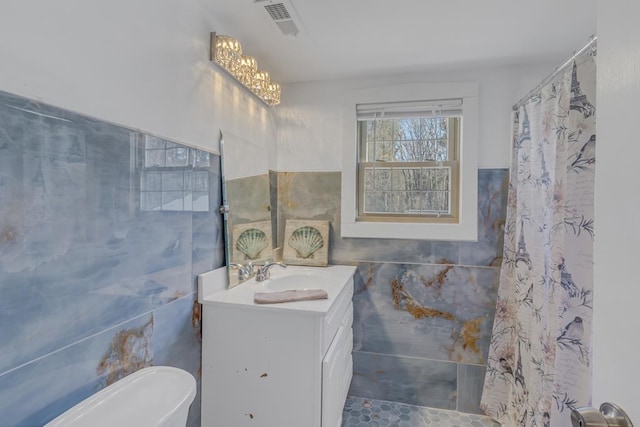 bathroom with vanity, tile walls, tile patterned floors, and a chandelier