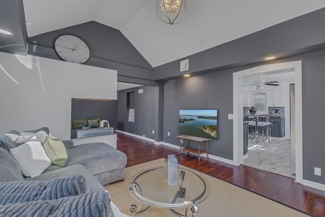 living room featuring hardwood / wood-style flooring, lofted ceiling, and ceiling fan