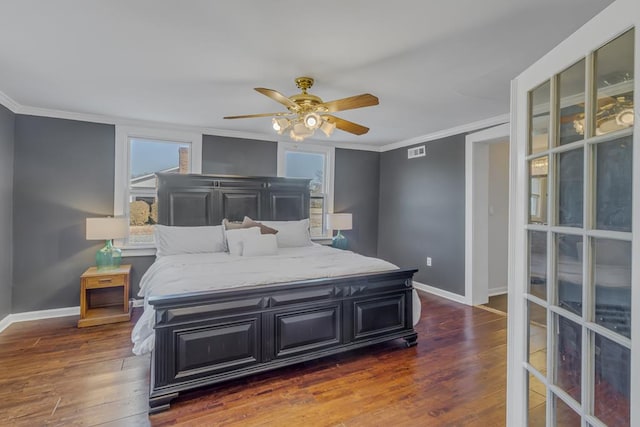 bedroom featuring ceiling fan, dark hardwood / wood-style flooring, and crown molding