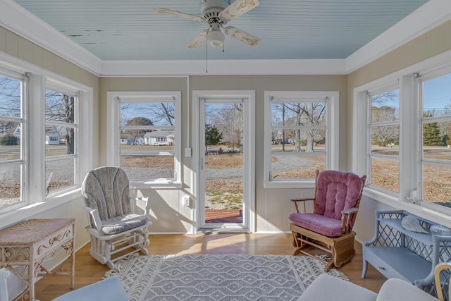 sunroom with ceiling fan and plenty of natural light