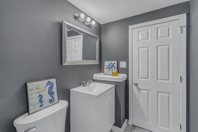 bathroom featuring toilet and vanity