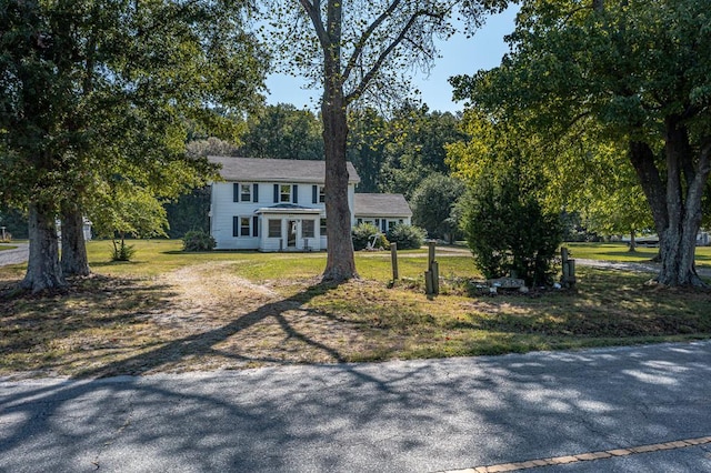 colonial inspired home featuring a front yard and a porch