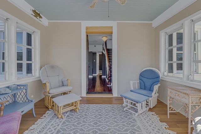 interior space with ceiling fan, hardwood / wood-style floors, and crown molding