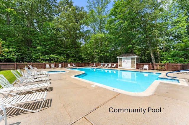 578 Canvasback Ln, Heathsville, VA 22473 - community pool featuring a patio area, a community hot tub, and view of scattered trees