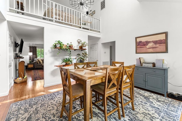578 Canvasback Ln, Heathsville, VA 22473 - dining area featuring light wood-type flooring, baseboards, and a high ceiling