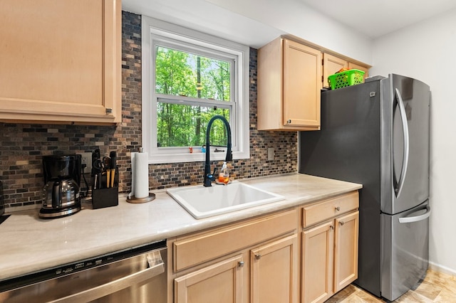 578 Canvasback Ln, Heathsville, VA 22473 - kitchen featuring a sink, appliances with stainless steel finishes, decorative backsplash, light brown cabinetry, and light countertops