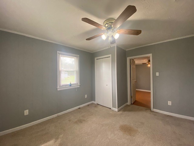 3097 Oakland Rd, Farnham, VA 22460 - unfurnished bedroom with ornamental molding, a closet, light colored carpet, and ceiling fan