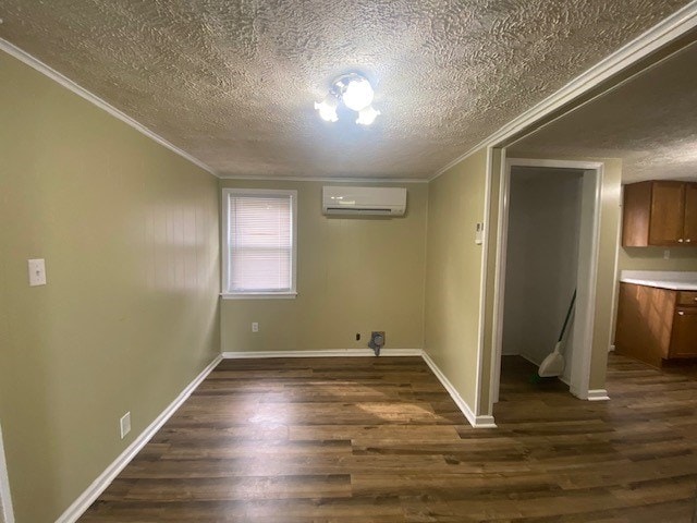 3097 Oakland Rd, Farnham, VA 22460 - below grade area with a wall mounted AC, ornamental molding, dark wood-type flooring, and a textured ceiling
