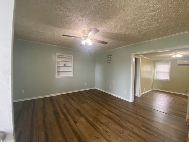 3097 Oakland Rd, Farnham, VA 22460 - empty room with a wall mounted AC, ornamental molding, a ceiling fan, wood finished floors, and a textured ceiling