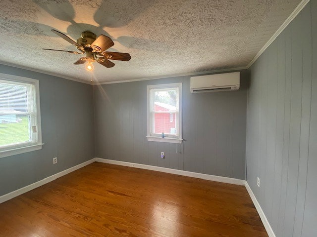 3097 Oakland Rd, Farnham, VA 22460 - spare room featuring a wall mounted AC, wood finished floors, a textured ceiling, ceiling fan, and crown molding