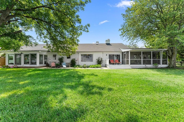 1743 Bushfield Rd, Montross, VA 22520 - back of property featuring a sunroom, a lawn, and a chimney