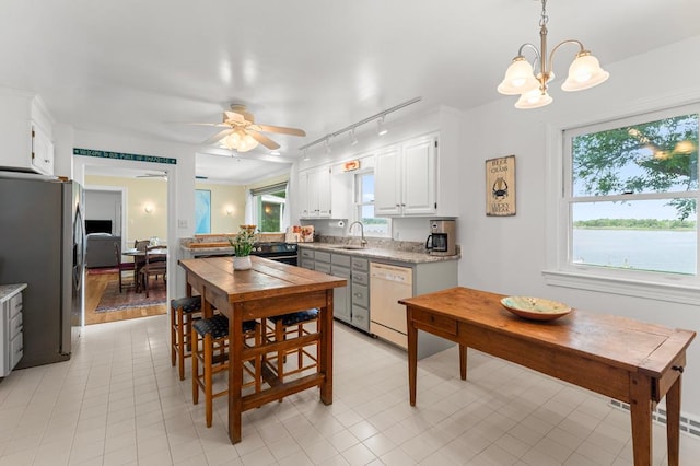 1743 Bushfield Rd, Montross, VA 22520 - kitchen with dishwasher, freestanding refrigerator, rail lighting, ceiling fan, and white cabinetry