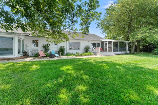 1743 Bushfield Rd, Montross, VA 22520 - back of property featuring a sunroom, a yard, stucco siding, and a shingled roof