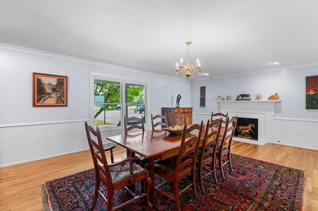 1743 Bushfield Rd, Montross, VA 22520 - dining room with wood finished floors, wainscoting, a chandelier, ornamental molding, and a fireplace