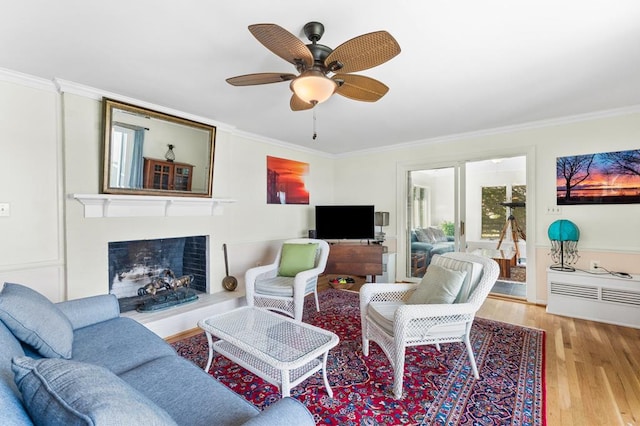 1743 Bushfield Rd, Montross, VA 22520 - living area featuring ornamental molding, wood finished floors, a fireplace with flush hearth, and a ceiling fan