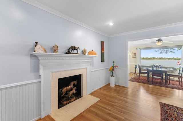 1743 Bushfield Rd, Montross, VA 22520 - living area featuring wood finished floors, crown molding, a fireplace with flush hearth, a ceiling fan, and a water view