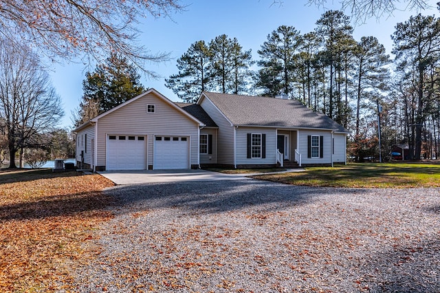 ranch-style house with a garage and a front lawn