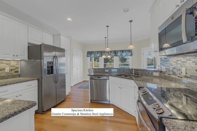 kitchen featuring backsplash, sink, white cabinetry, and stainless steel appliances