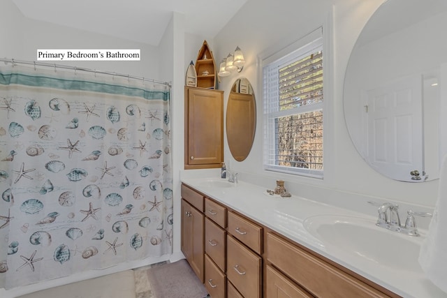 bathroom with tile patterned floors, vanity, and lofted ceiling