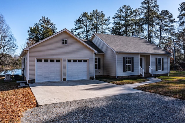 view of front of home featuring cooling unit and a garage